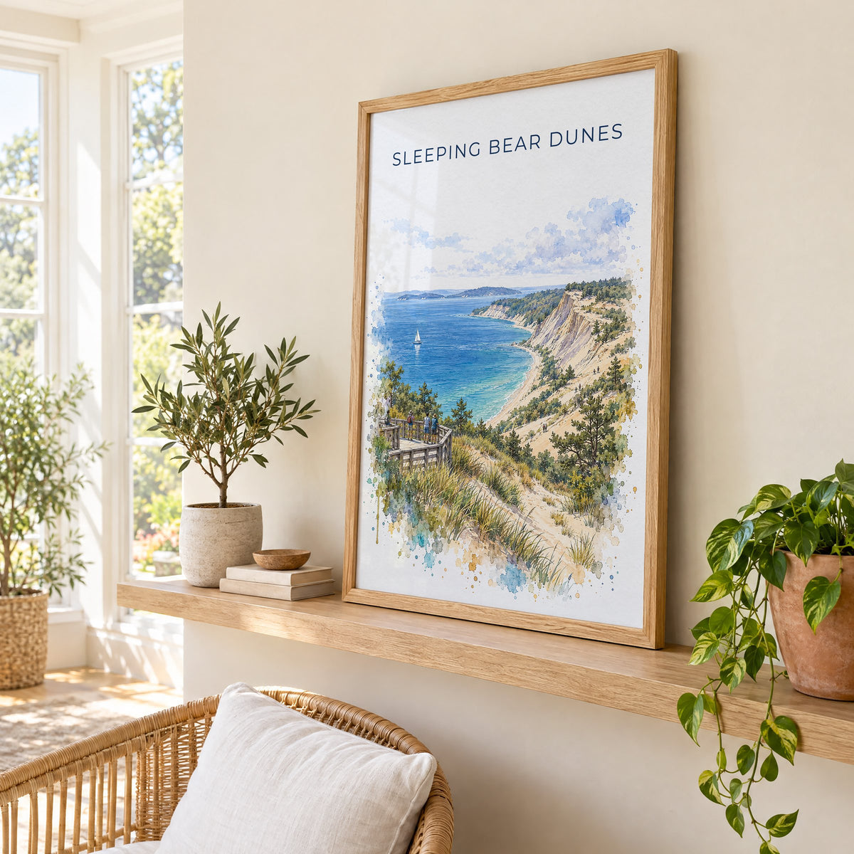 Sleeping Bear Dunes watercolor print in an oak frame on a picture ledge in a sunlit sunroom