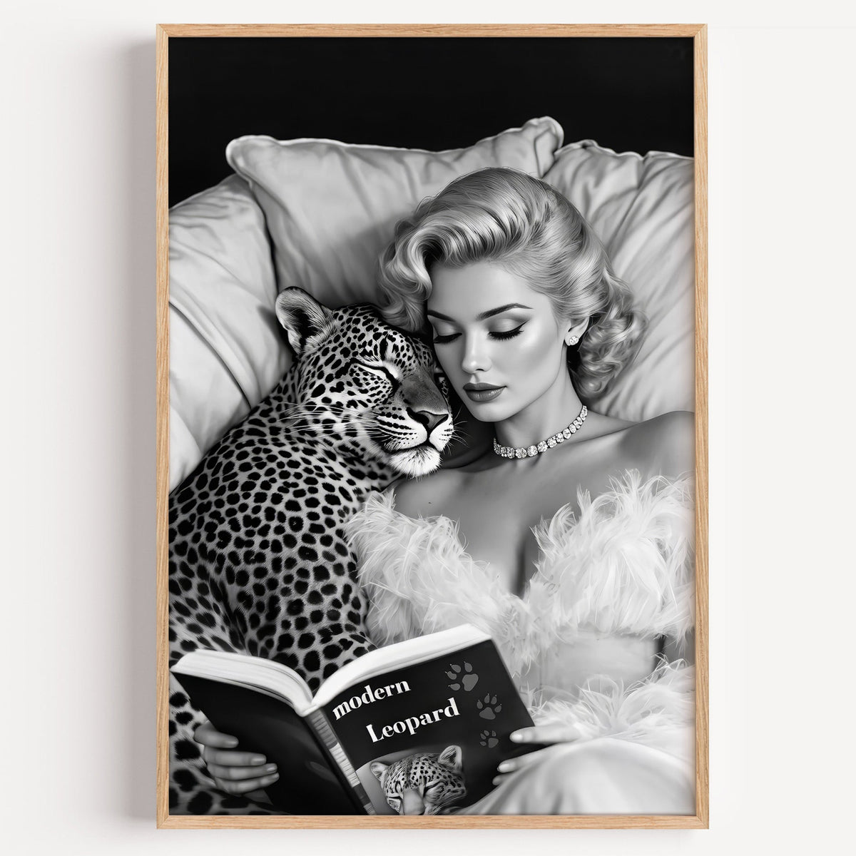 Woman asleep on pillows with leopard and book print in a light oak frame on a plain white wall