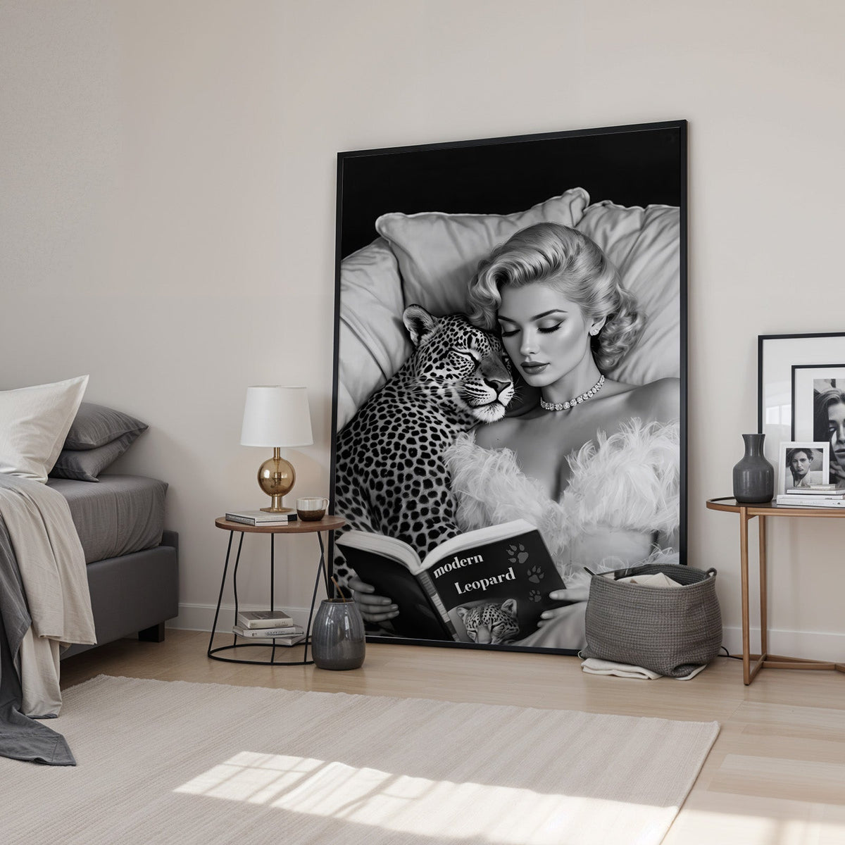 Woman asleep on pillows with leopard and book print in a black frame leaning in a bedroom beside a gold lamp