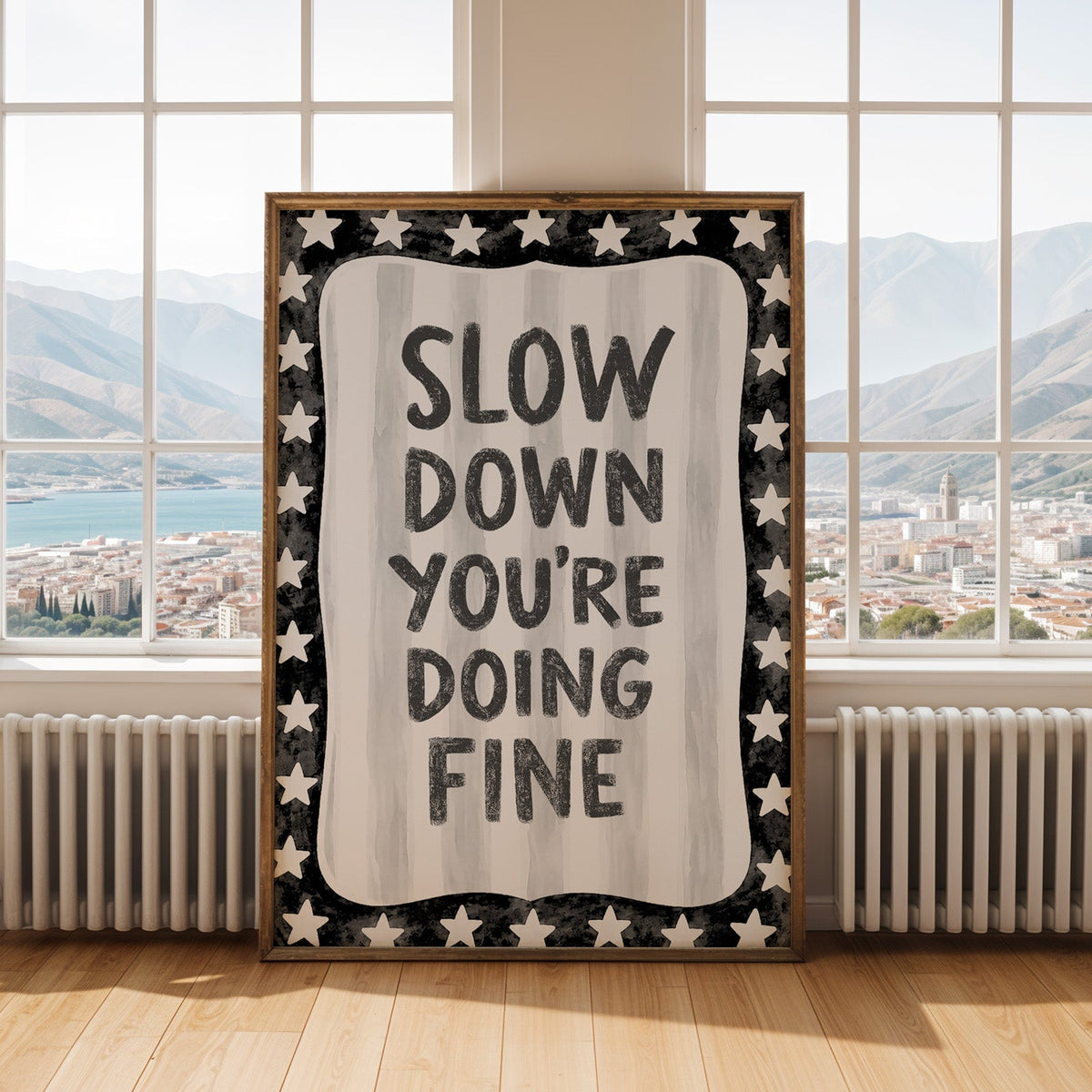 Slow down you're doing fine quote with star border print shown in an antique gold frame by tall windows with a sea view