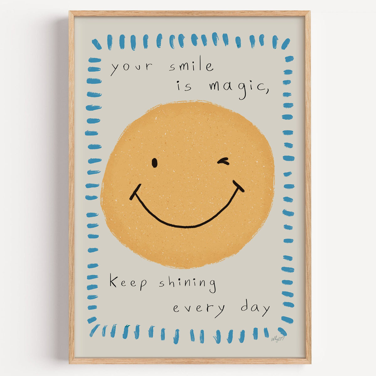 Winking smiley face quote nursery print in a light oak frame on a plain white wall