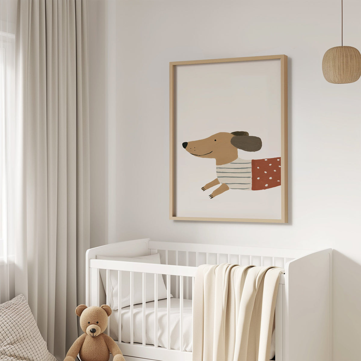 Smiling dachshund close-up nursery print in an oak frame above a white crib with a teddy bear