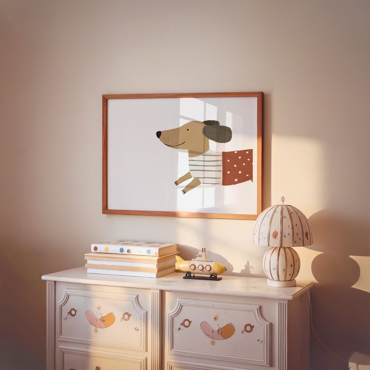 Landscape smiling dachshund close-up nursery print in a cherry wood frame above a painted dresser and lamp