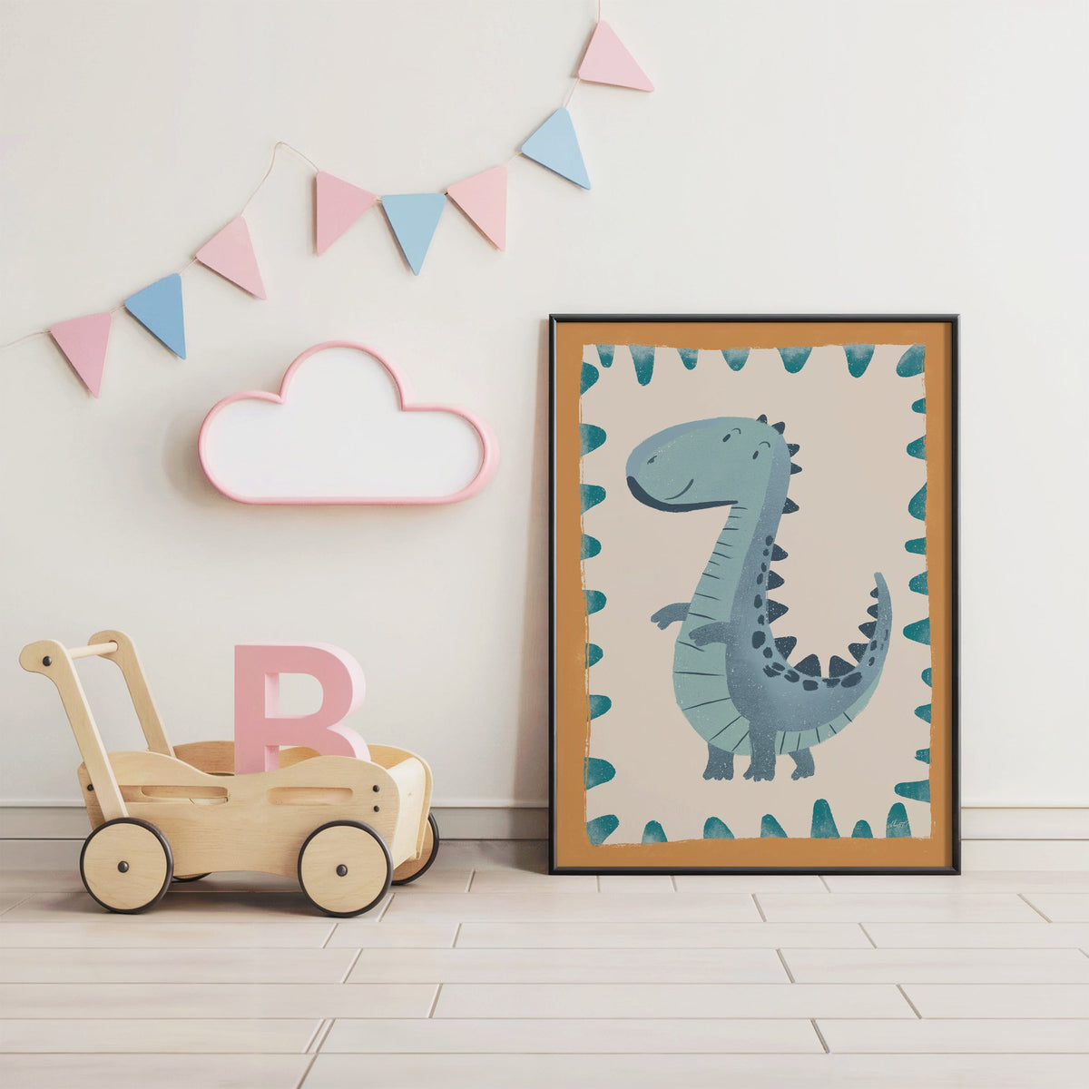 Smiling teal dinosaur nursery print in a black frame under pastel bunting by a wooden baby walker