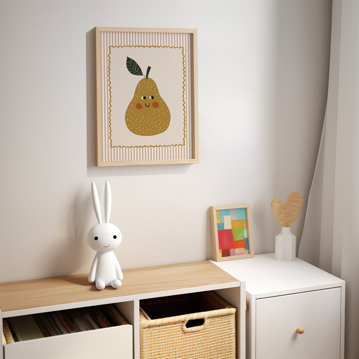 Smiling pear pink stripe nursery print in an oak frame above a kids cubby shelf with a woven basket and bunny lamp