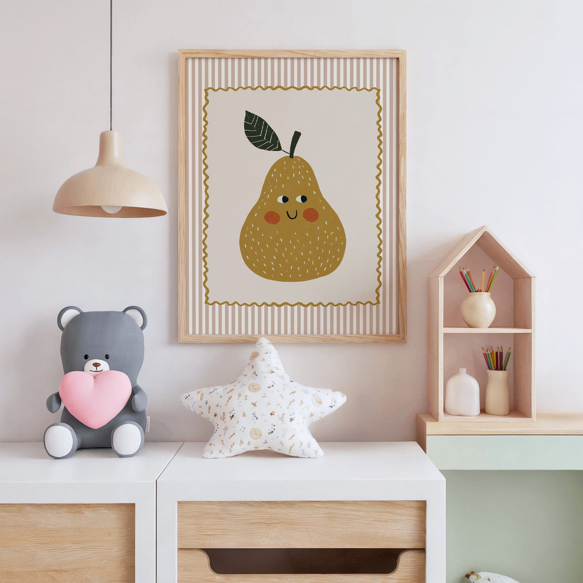 Smiling pear pink stripe nursery print in an oak frame above a white dresser with a star pillow and house shelf
