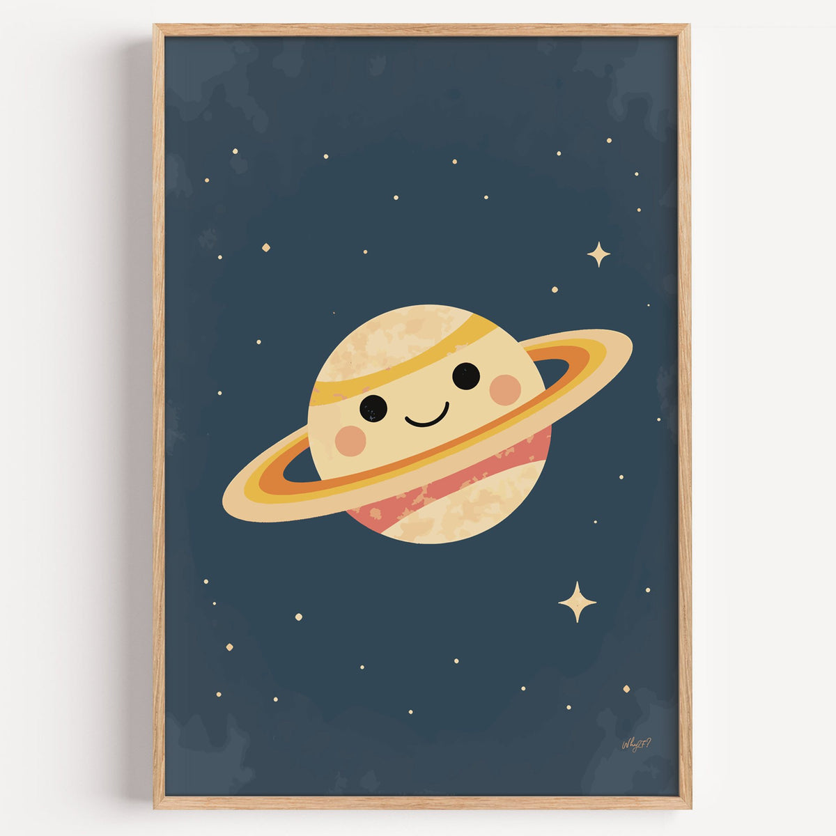 Smiling saturn with rosy cheeks nursery print in a light oak frame on a plain white wall