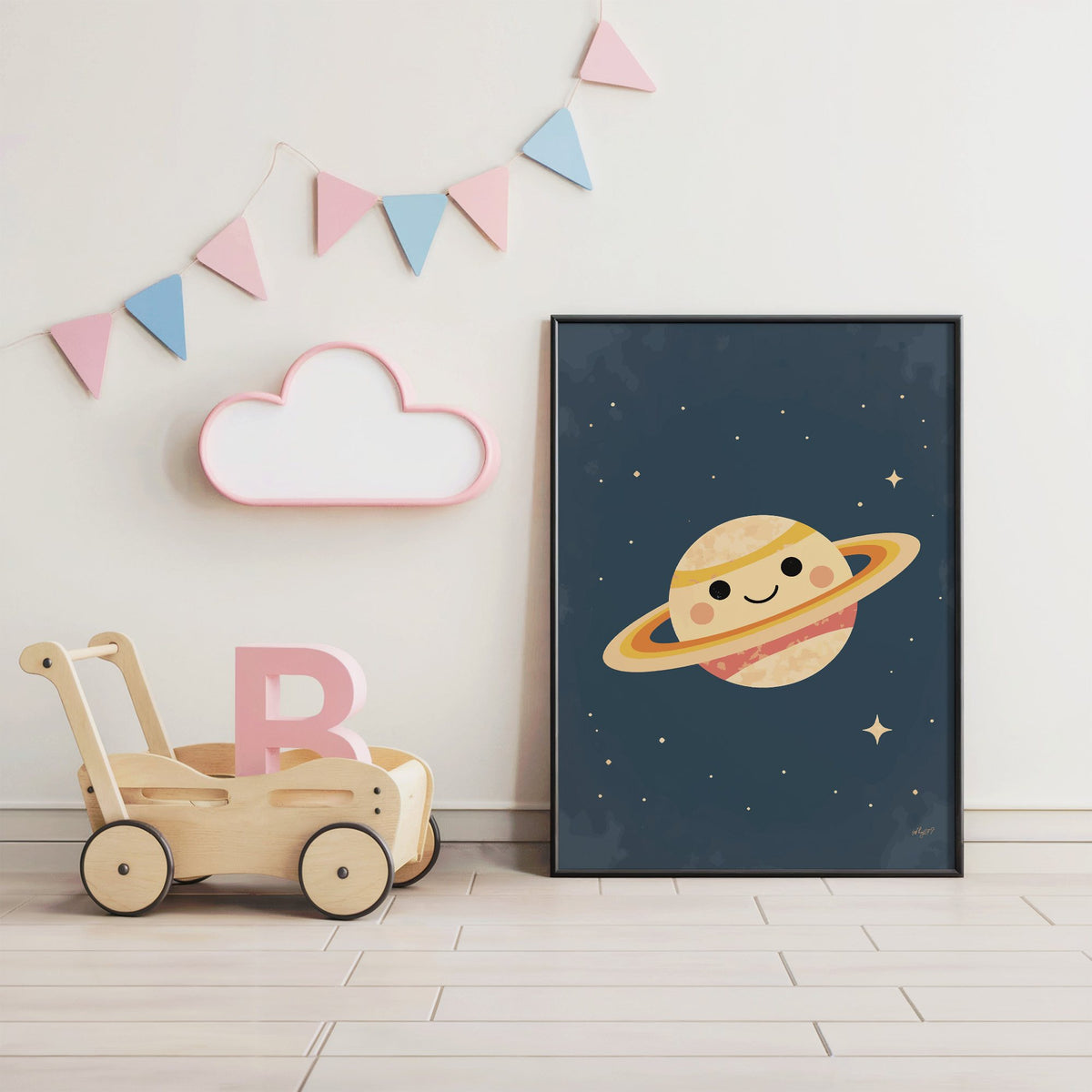 Smiling saturn with rosy cheeks nursery print in a black frame under pastel bunting by a wooden baby walker