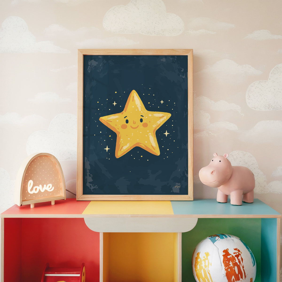Smiling yellow star on navy nursery print in an oak frame on a rainbow toy shelf against cloud wallpaper