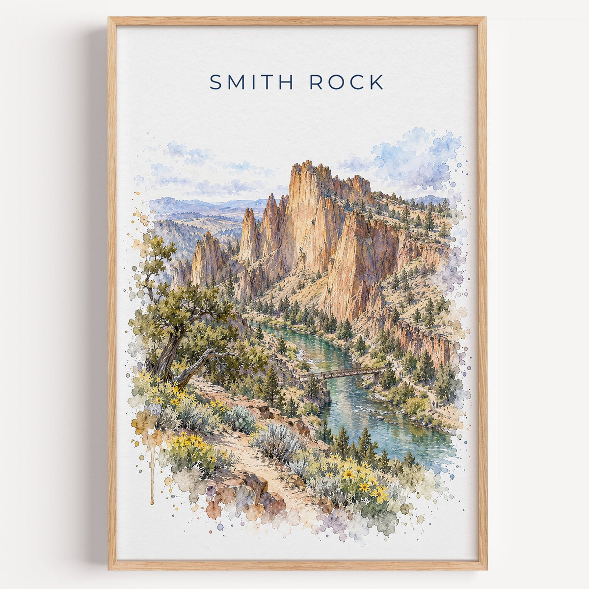 Smith Rock watercolor print in a light oak frame on a plain white wall