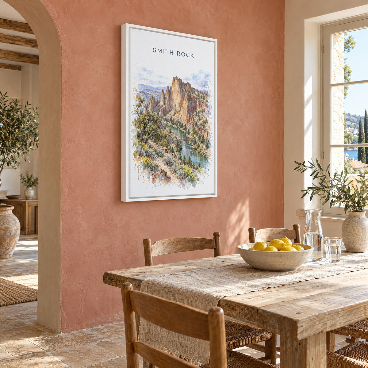 Smith Rock watercolor print as a white floater canvas on a terracotta wall above a rustic dining table
