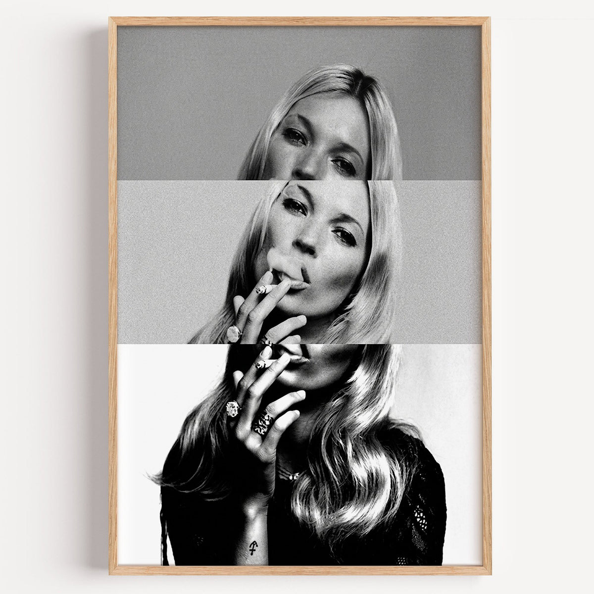 Sliced black and white smoking woman portrait print in a light oak frame on a plain white wall