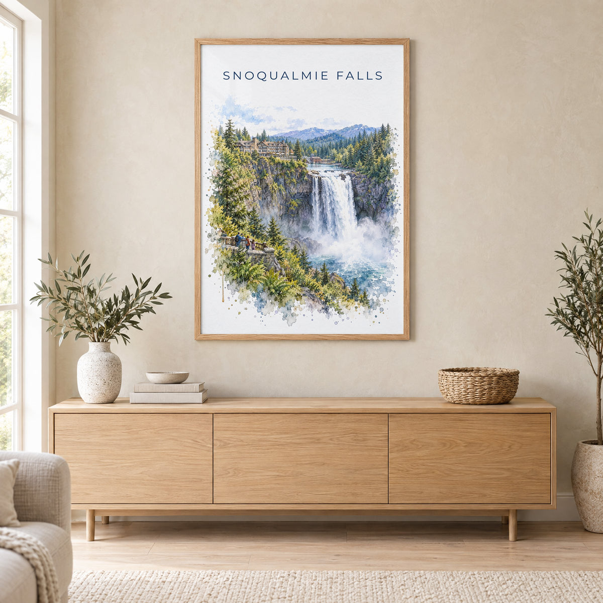 Snoqualmie Falls watercolor print in an oak frame above a light wood sideboard in a Scandinavian living room