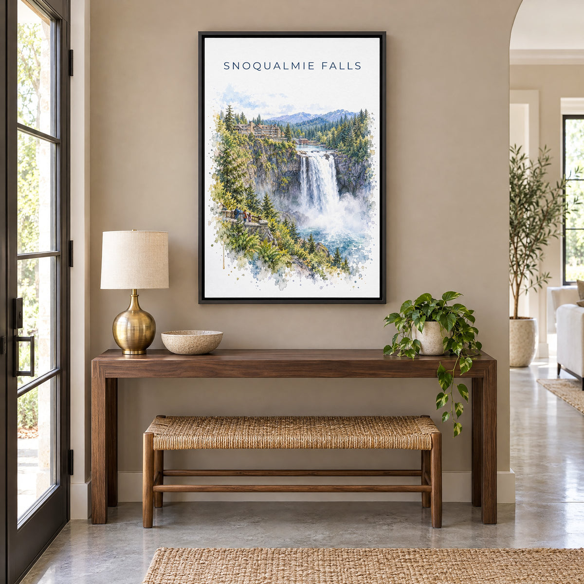Snoqualmie Falls watercolor print as a black floater canvas above a walnut console and woven bench in an entryway