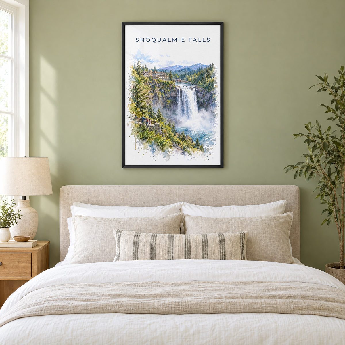 Snoqualmie Falls watercolor print in a black frame above an upholstered headboard in a sage green bedroom