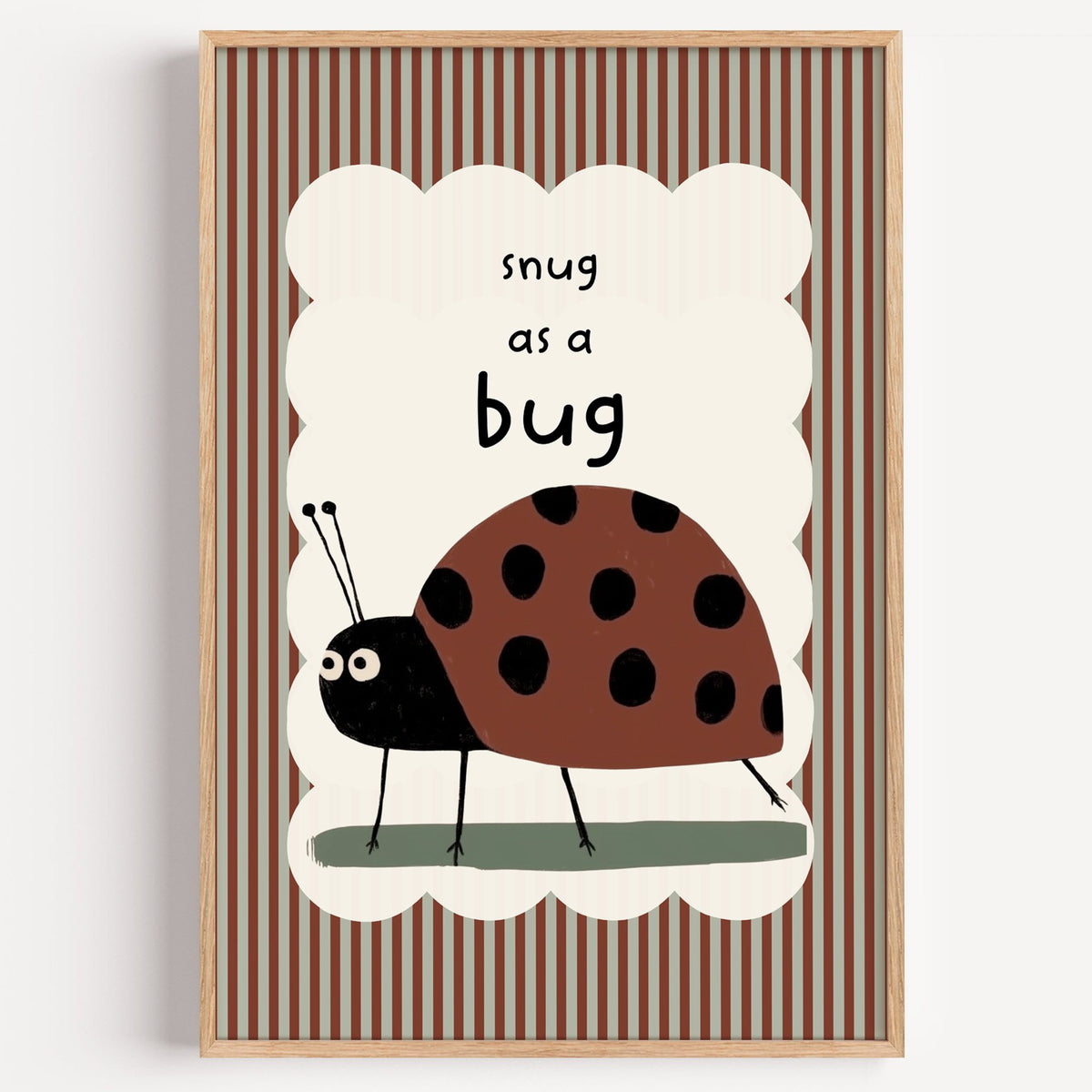 Snug as a bug ladybug nursery print in a light oak frame on a plain white wall