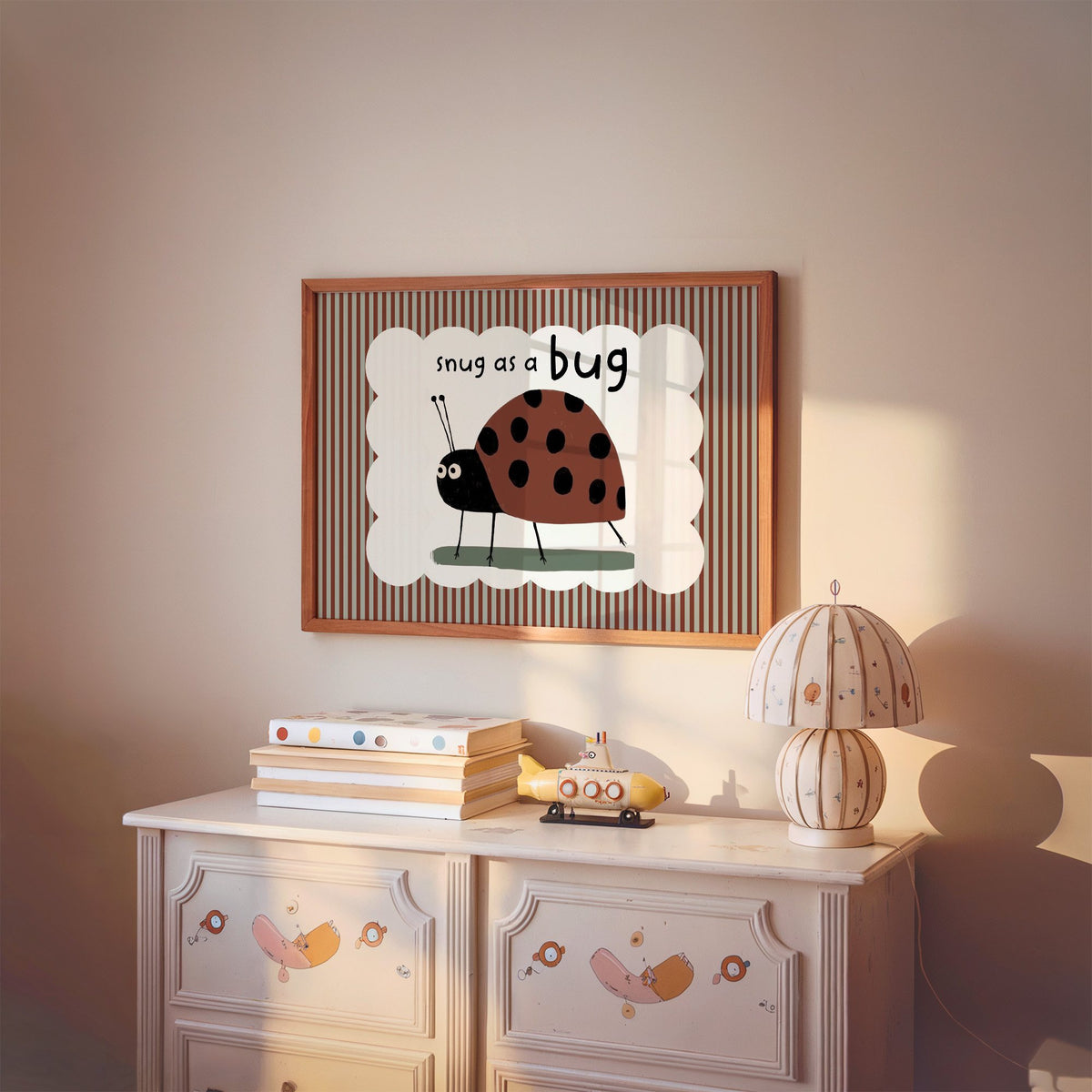 Landscape snug as a bug ladybug nursery print in a cherry wood frame above a painted dresser and lamp