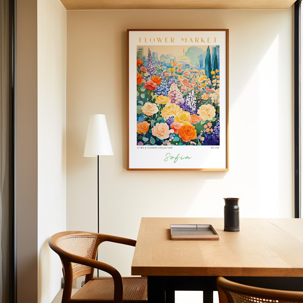 Sofia flower market print in an oak frame above a dining table and cane chair