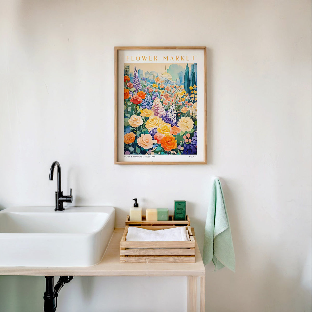 Sofia flower market print in an oak frame above a white bathroom sink with folded towels