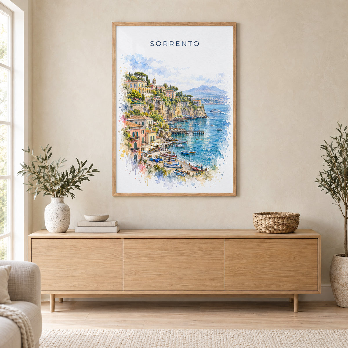 Sorrento watercolor print in an oak frame above a light wood sideboard in a Scandinavian living room