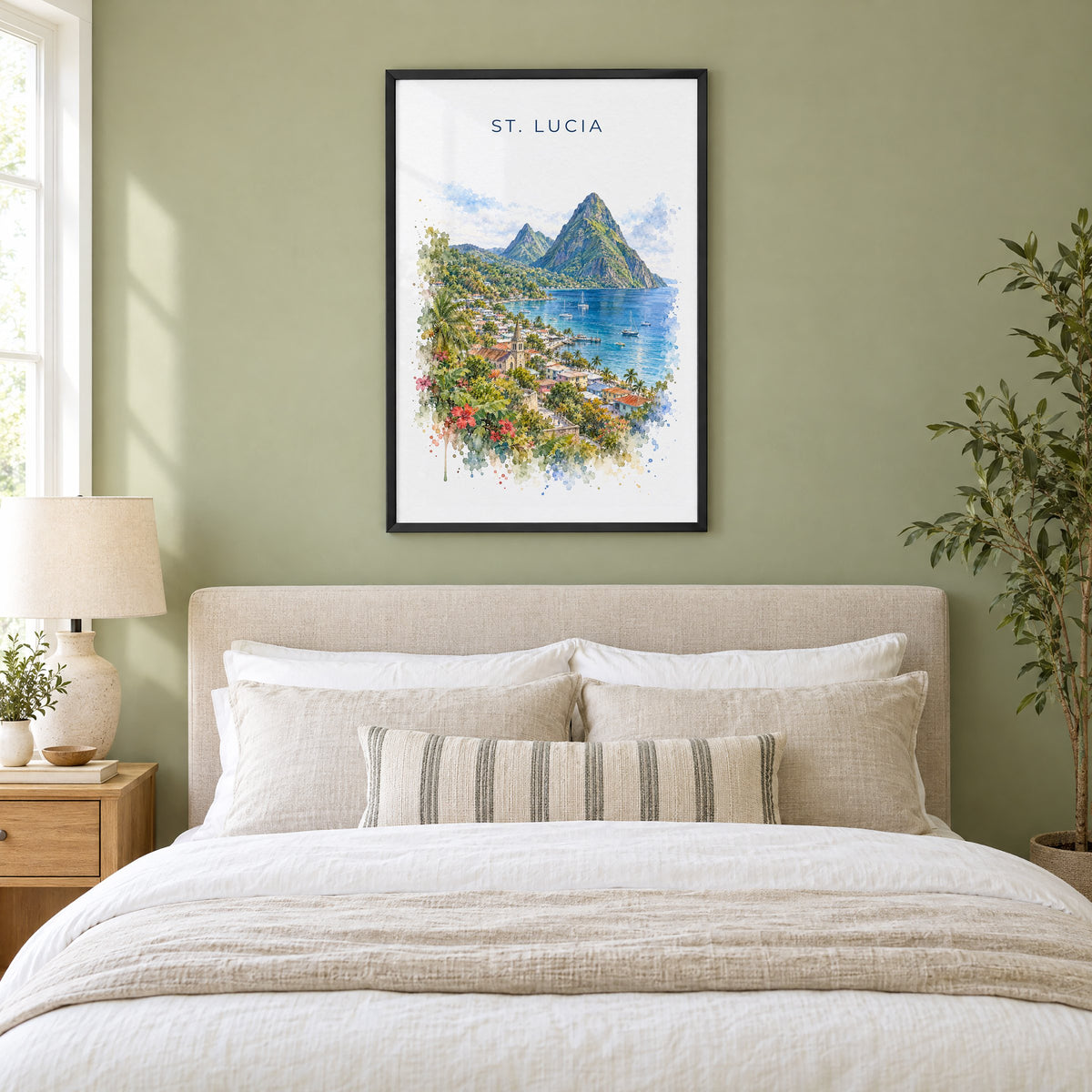 Saint Lucia Pitons watercolor print in a black frame above an upholstered headboard in a sage green bedroom