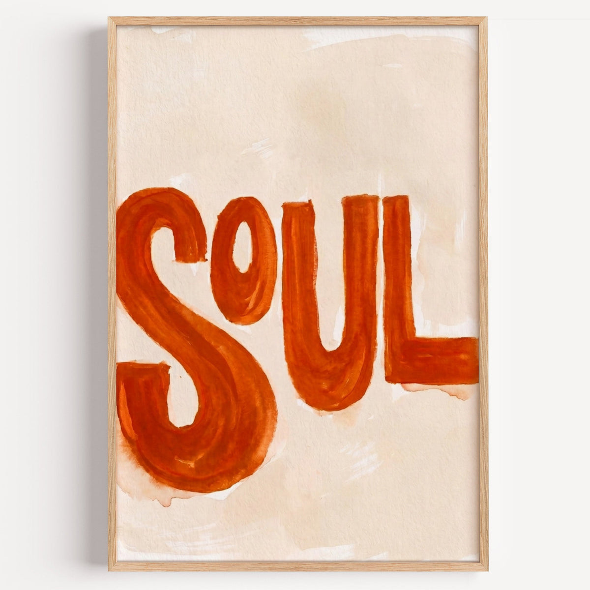 Soul hand lettered print in a light oak frame on a plain white wall