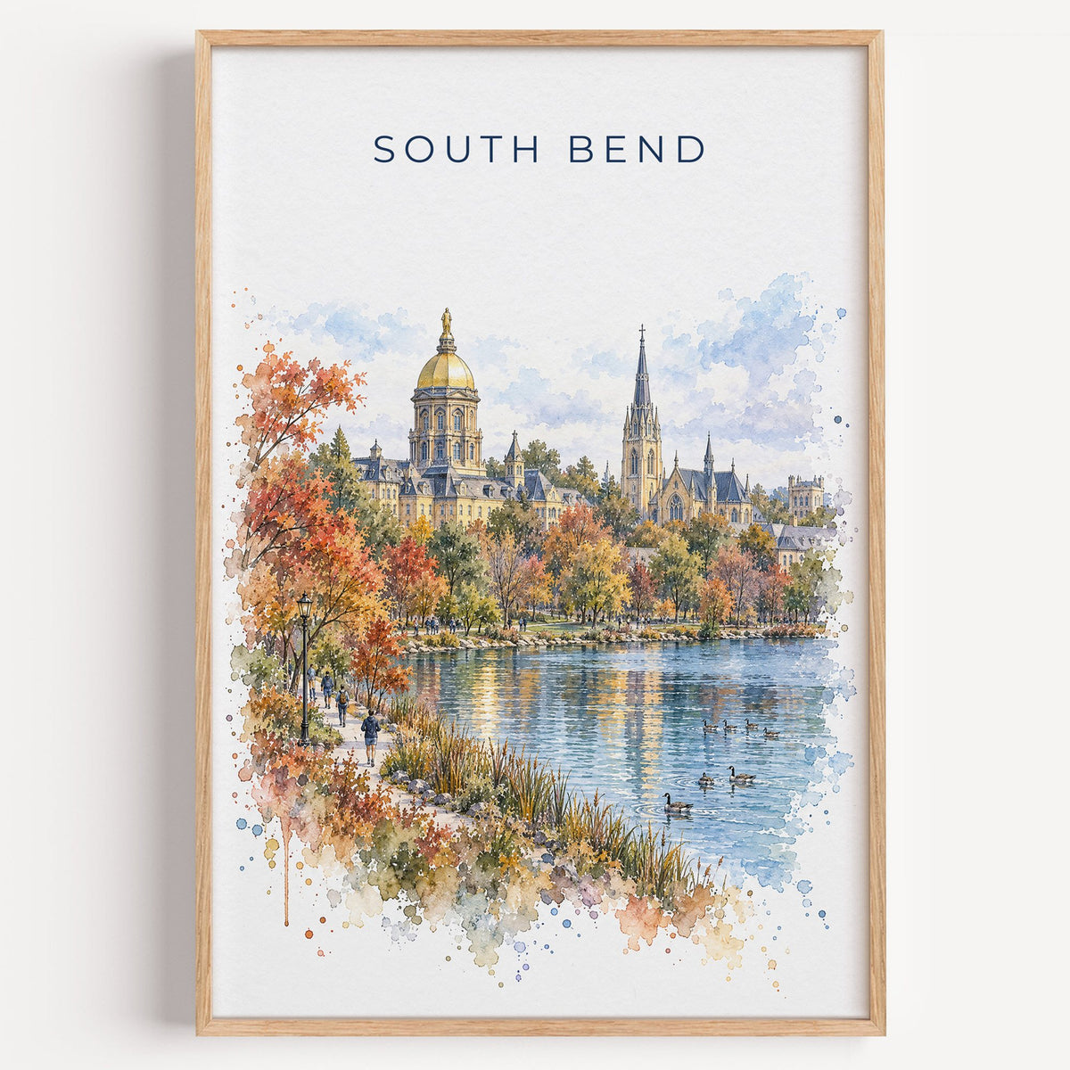 South Bend watercolor print in a light oak frame on a plain white wall