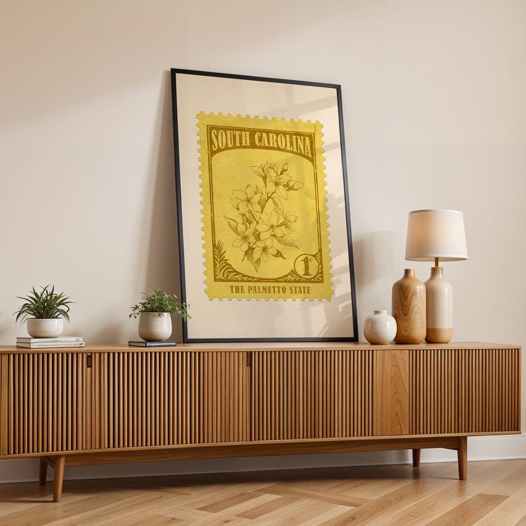South Carolina state flower print in a black frame leaning on a fluted wood credenza with vases and a lamp