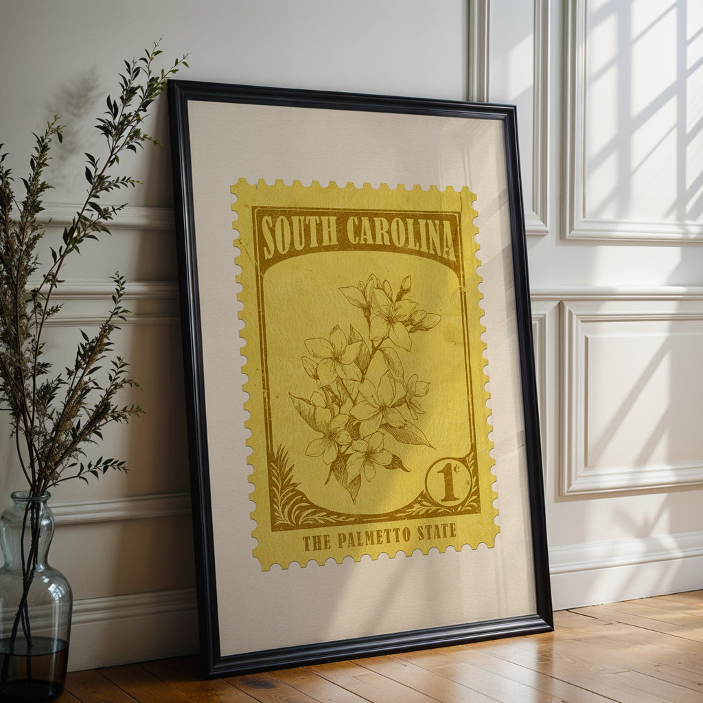 South Carolina state flower print in a black frame leaning on a white panelled wall beside olive branches
