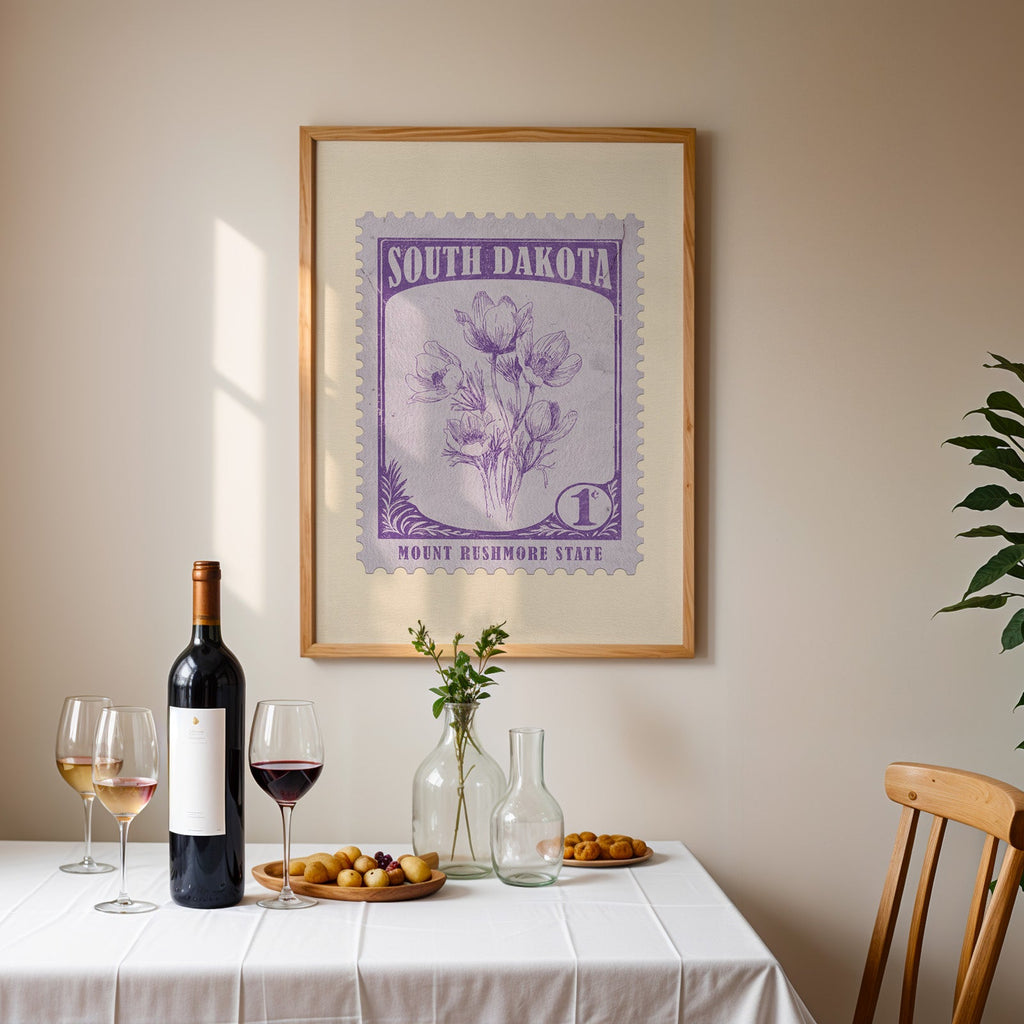 South Dakota stamp print framed on the wall above a dining table set with wine, glasses and olives
