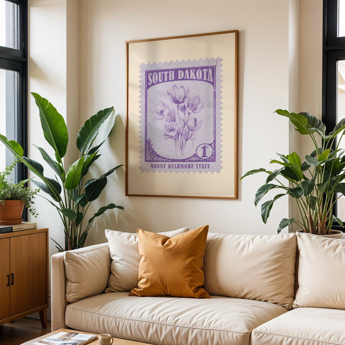 South Dakota state flower print framed above a cream sofa with an ochre cushion and large plants
