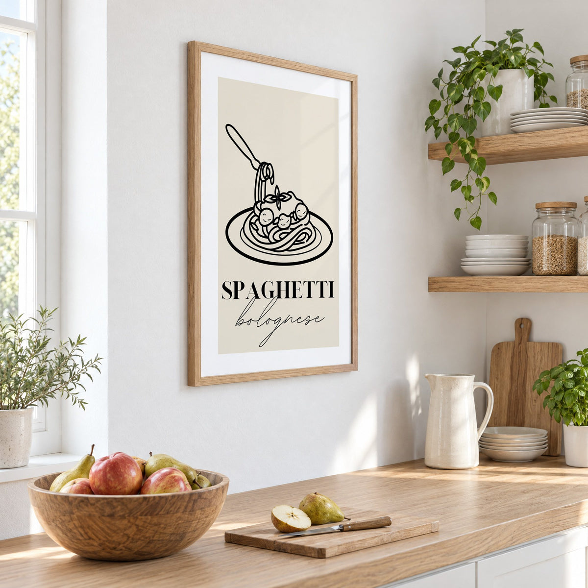 SPAGHETTI bolognese black line meatballs print in an oak frame on a white kitchen wall above a counter with apples and pears, seen at an angle