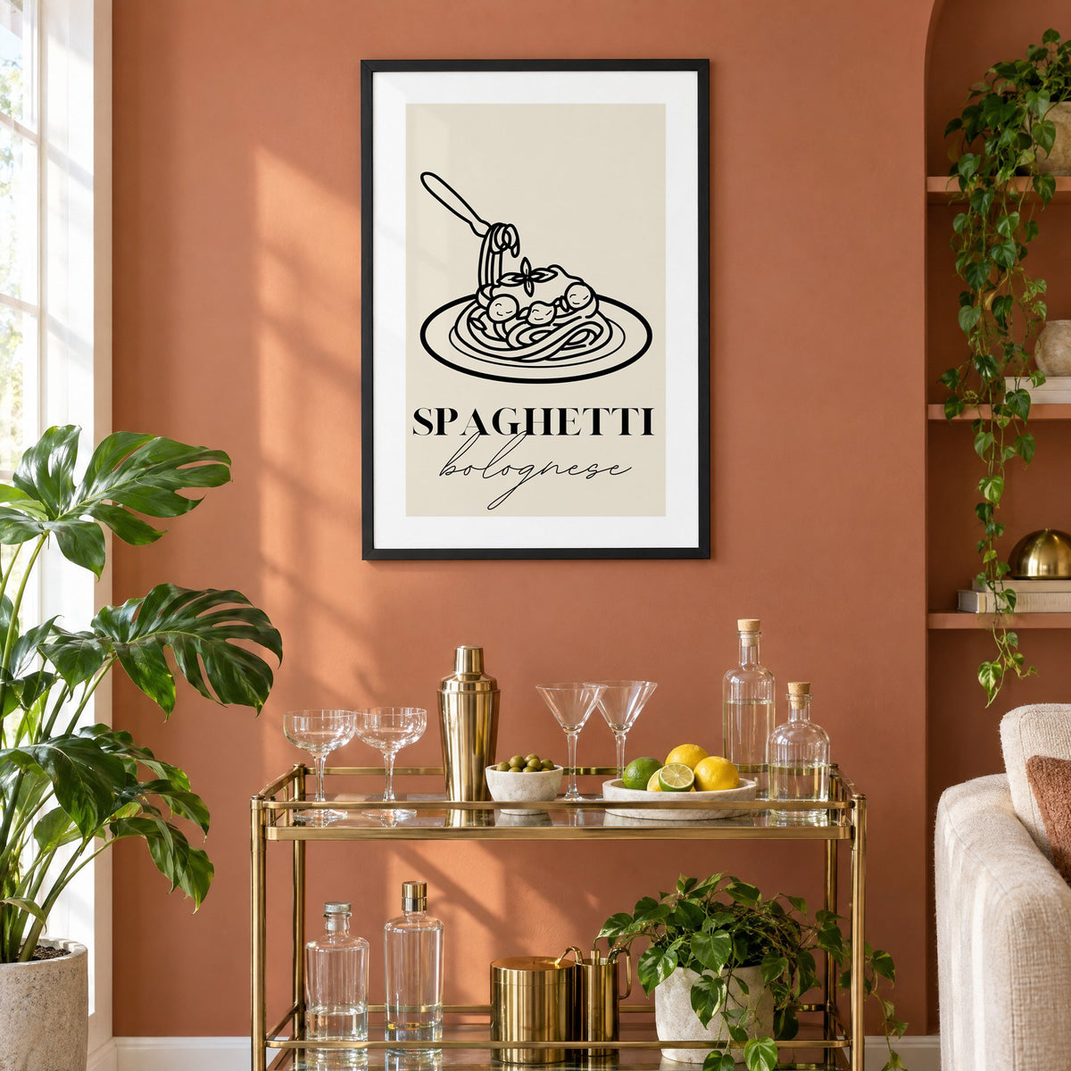 SPAGHETTI bolognese black line meatballs print in a black frame on a terracotta wall above a brass bar cart with coupes and citrus