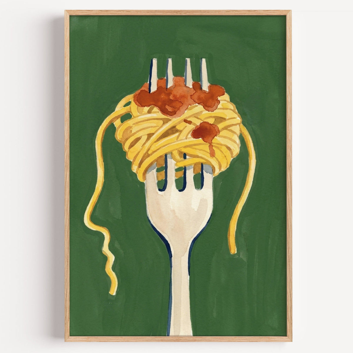 Spaghetti on a fork print in a light oak frame on a plain white wall