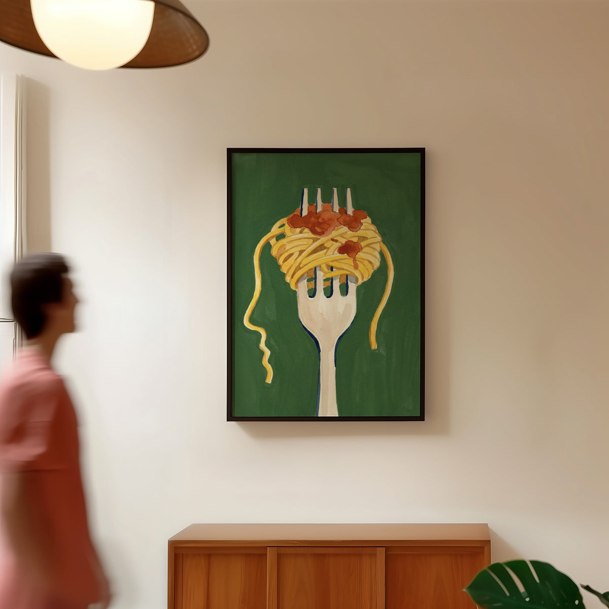 Green pasta wall art print in a black frame in a hallway under a rattan pendant