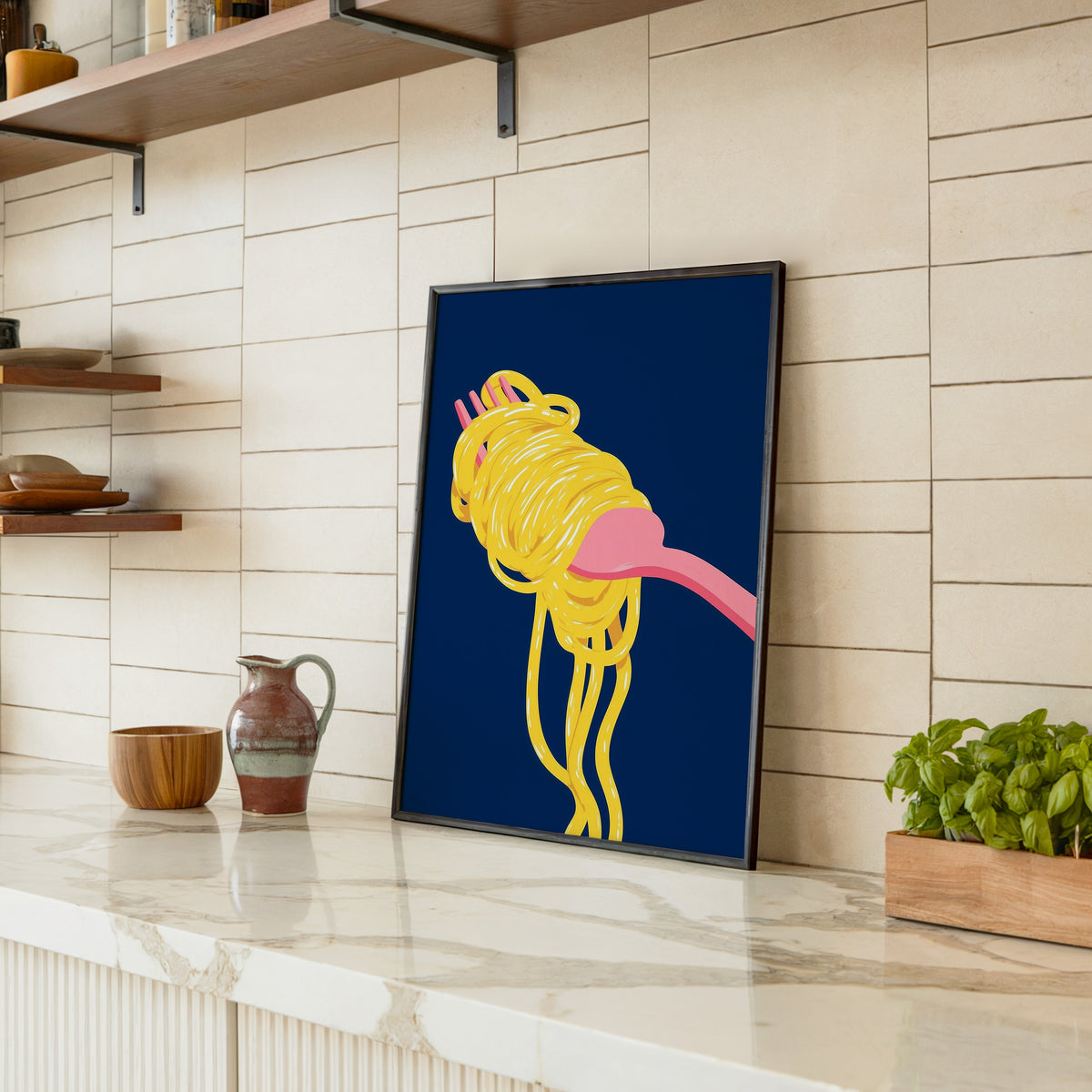 Spaghetti navy print in a black frame leaning on a marble counter in a tiled kitchen