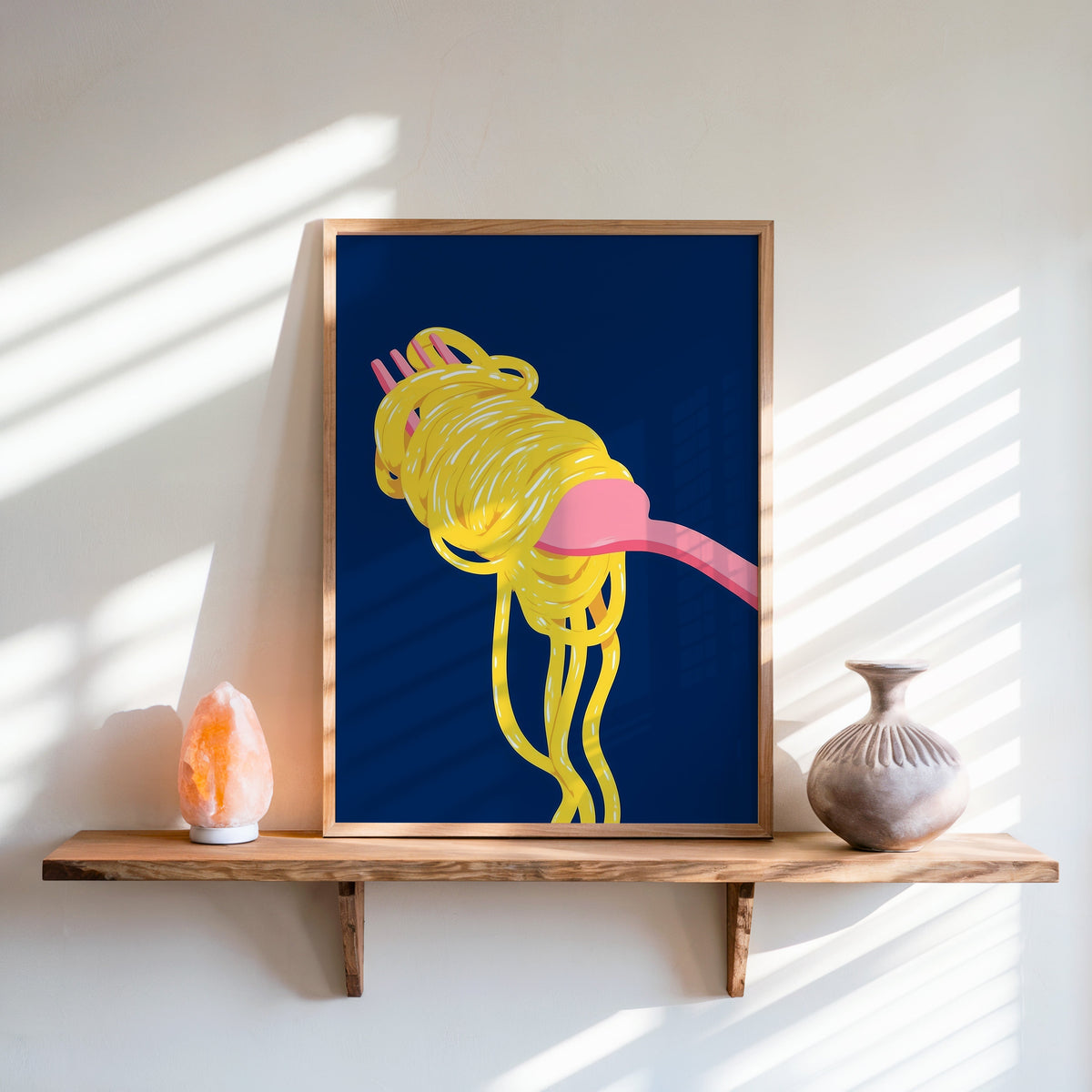 Spaghetti navy print in an oak frame on a live-edge shelf beside a salt lamp