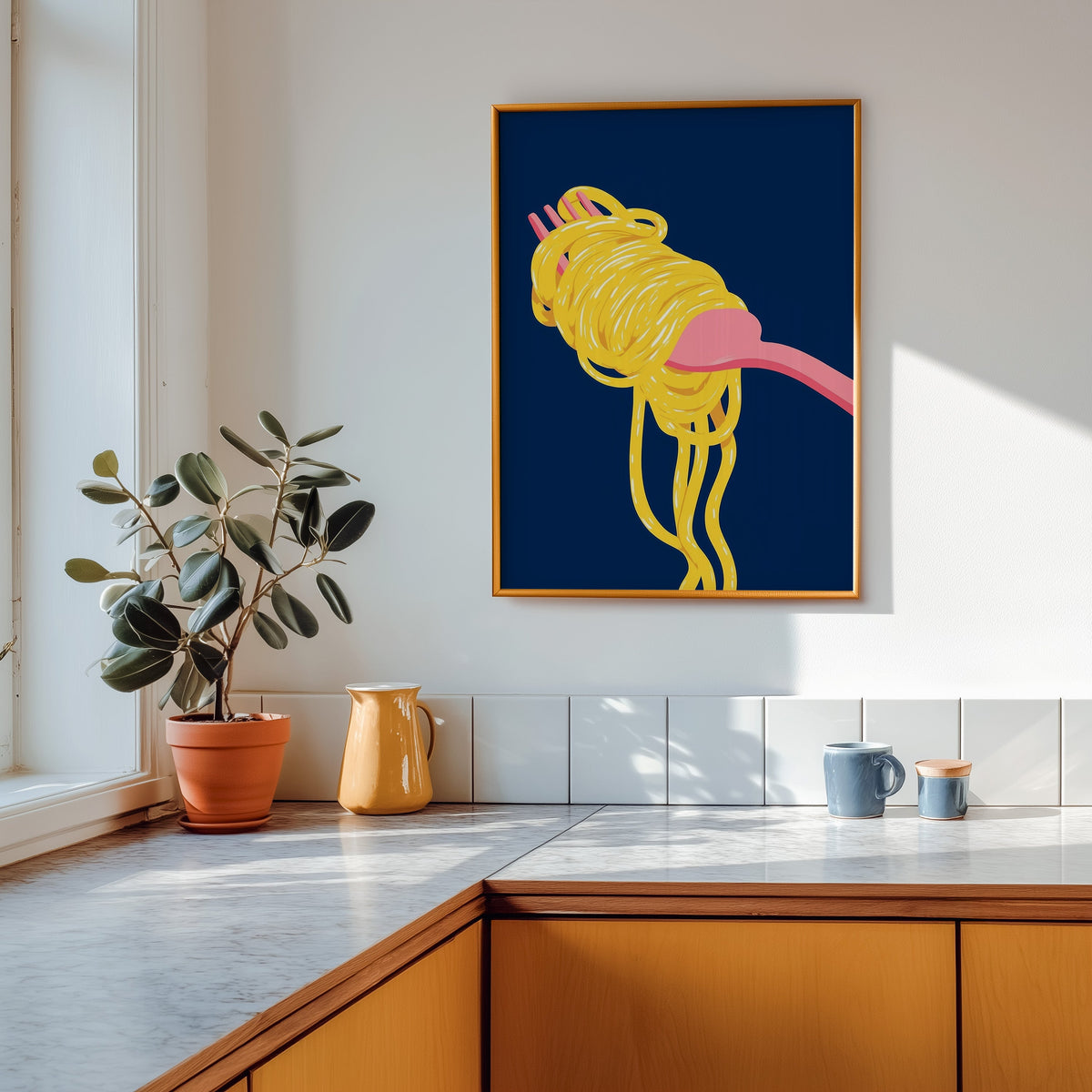 Spaghetti navy print shown in a gold frame above a marble counter in a tan kitchen