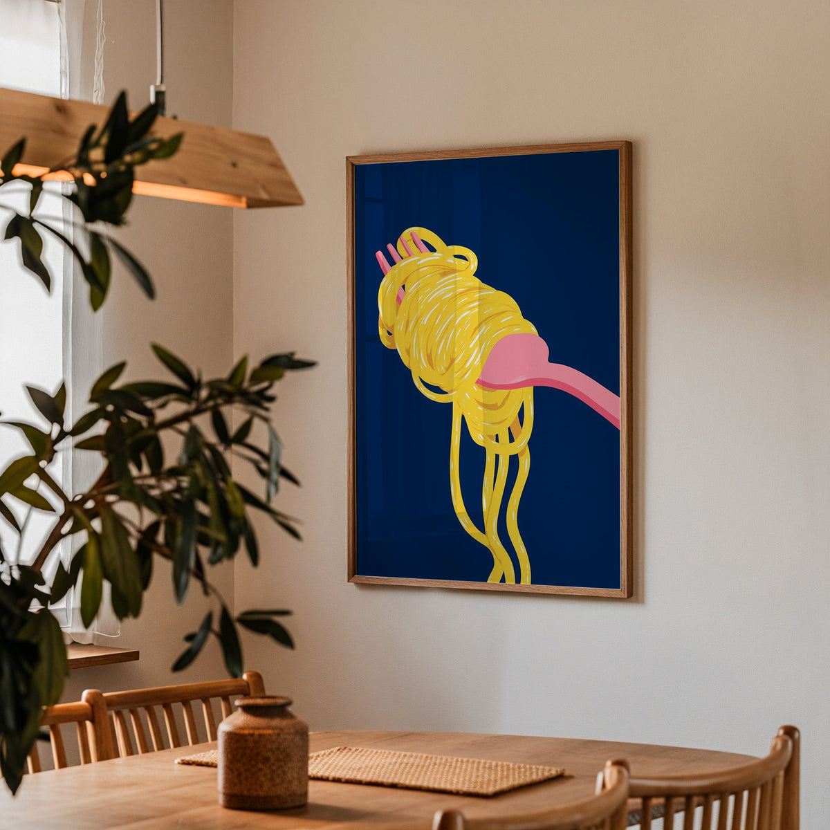Spaghetti navy print in a walnut frame above a dining table with olive branches