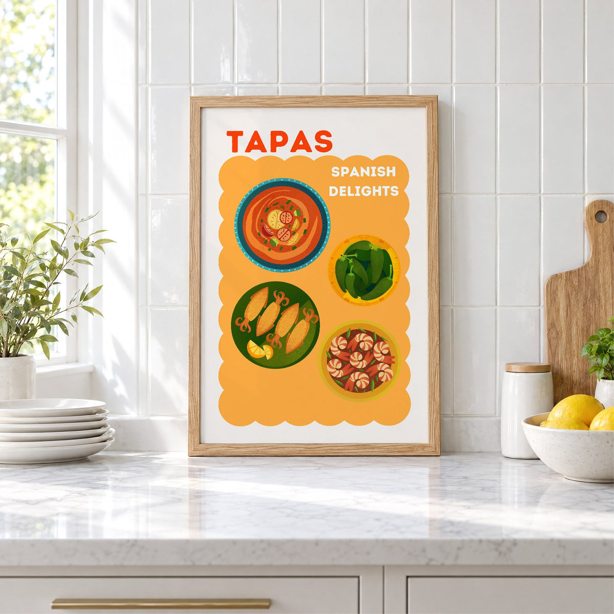 Spanish tapas four plates print in an oak frame leaning on a marble counter by white tiles and lemons