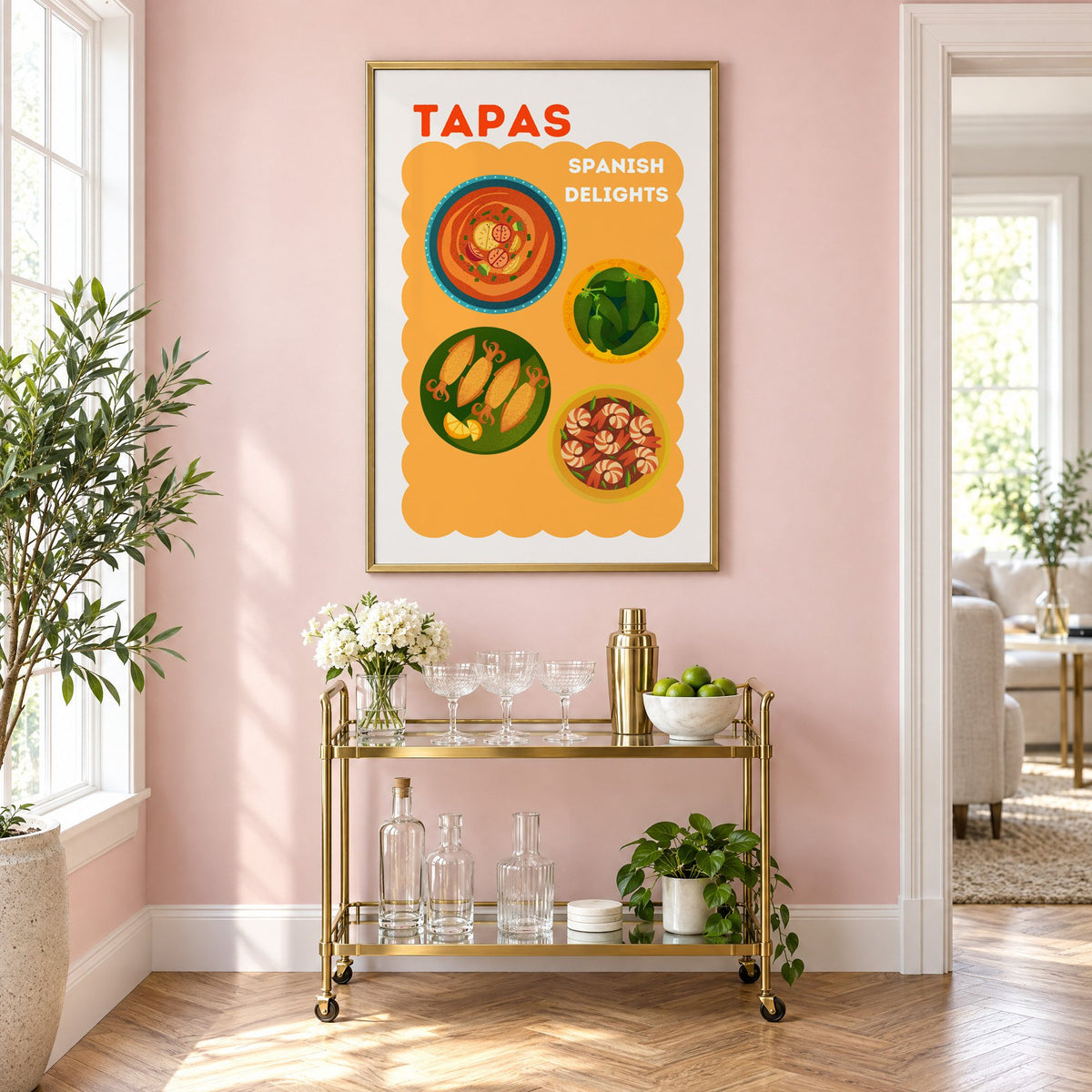 Spanish tapas four plates print in a brass frame above a gold bar cart on a blush pink wall