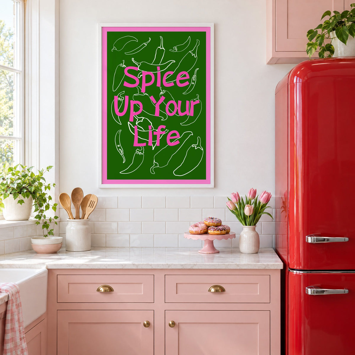Spice Up Your Life green chilli print in a white frame in a pink kitchen beside a red retro fridge