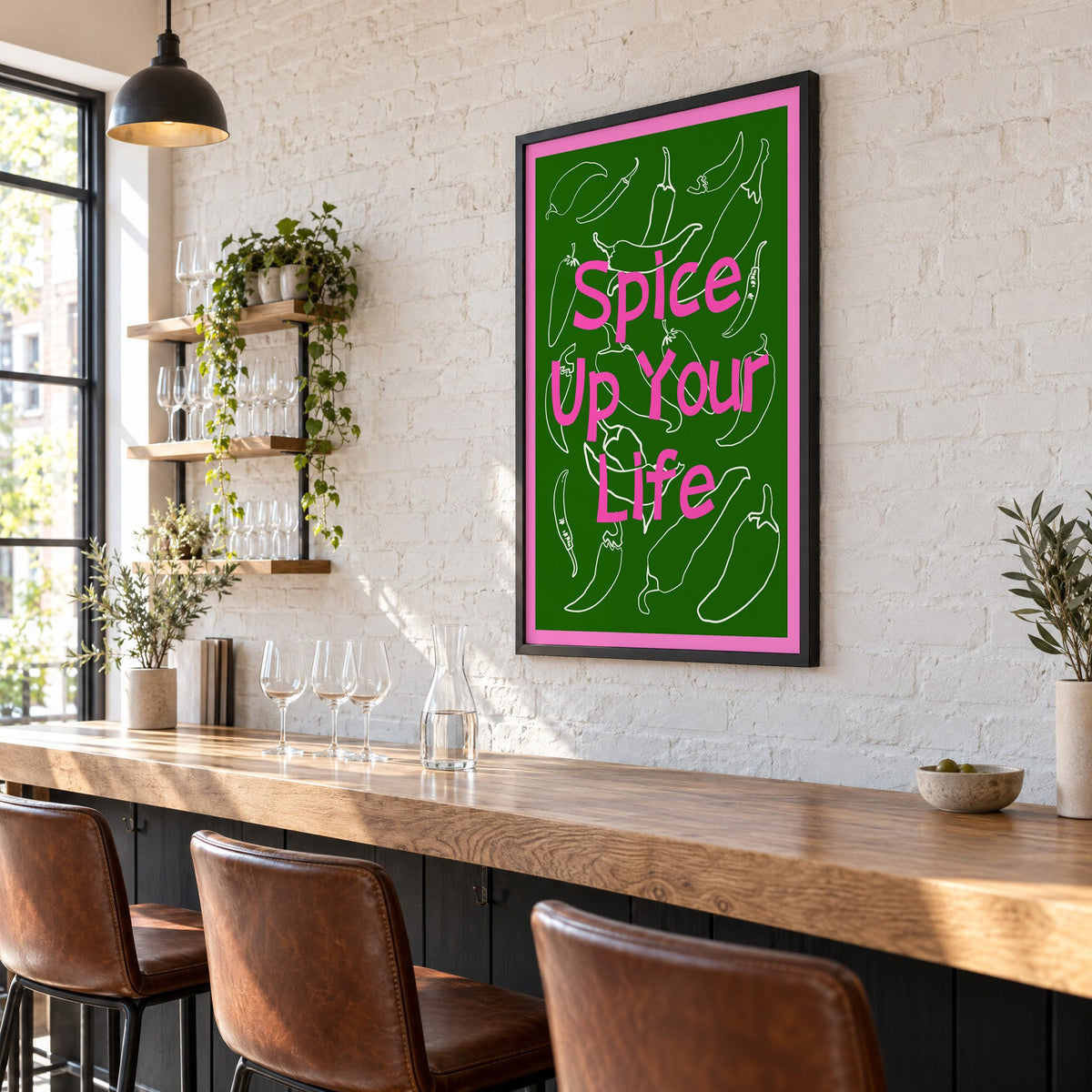 Spice Up Your Life green chilli print in a black frame on a white brick wall above a wine bar counter