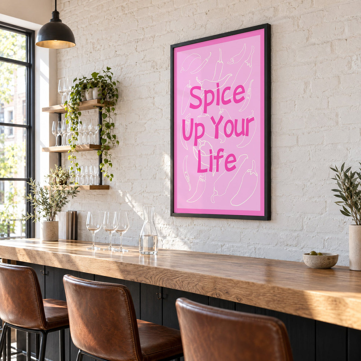 Spice Up Your Life pink chilli print in a black frame on a white brick wall above a wine bar counter