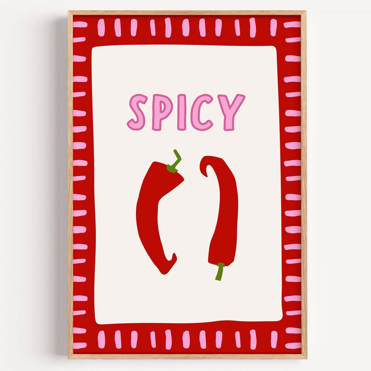 Spicy chilli red frame print in a light oak frame on a plain white wall