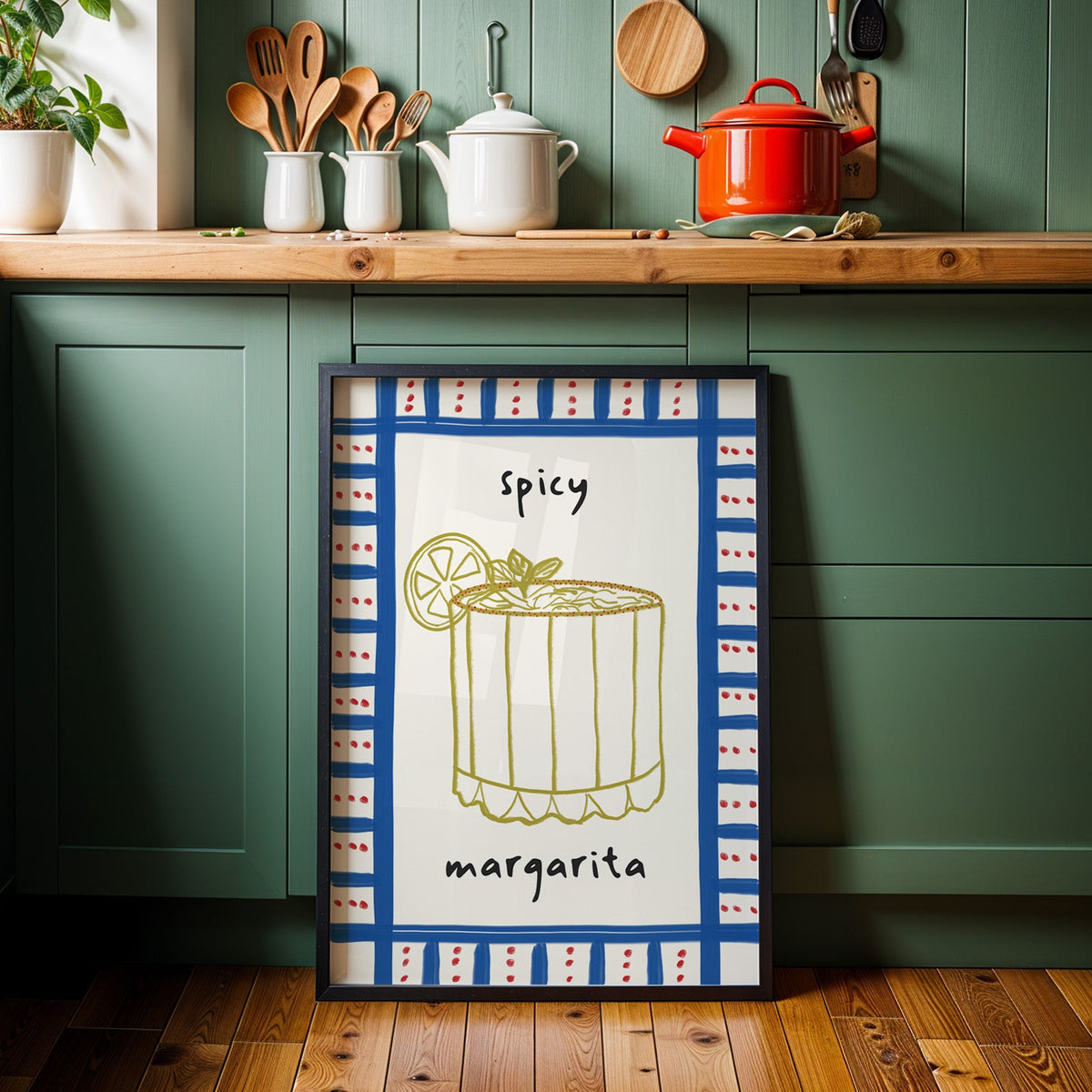 Spicy margarita gingham print in a black frame against sage green kitchen cabinets