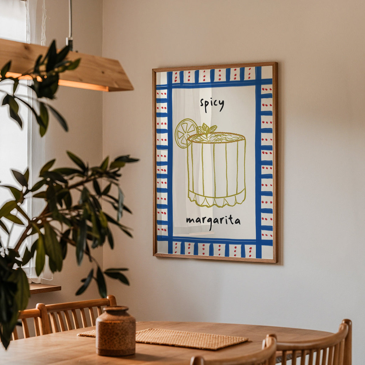 Spicy margarita gingham print in a walnut frame above a table beside an olive tree