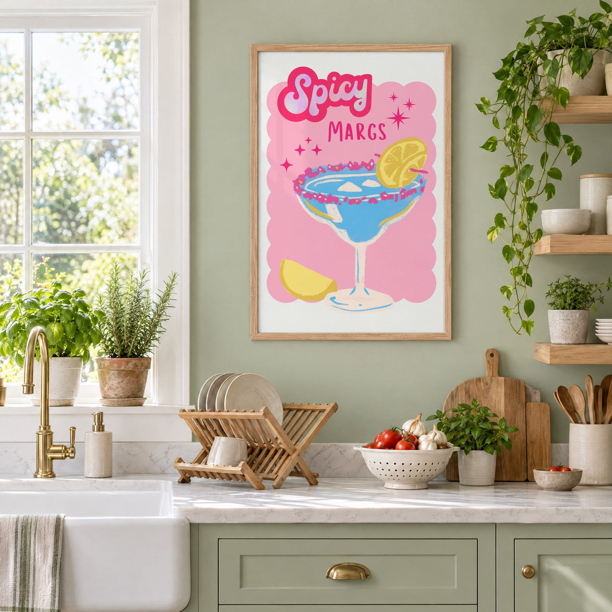 Spicy Margs blue margarita print in an oak frame on a sage green kitchen wall beside a farmhouse sink and herbs
