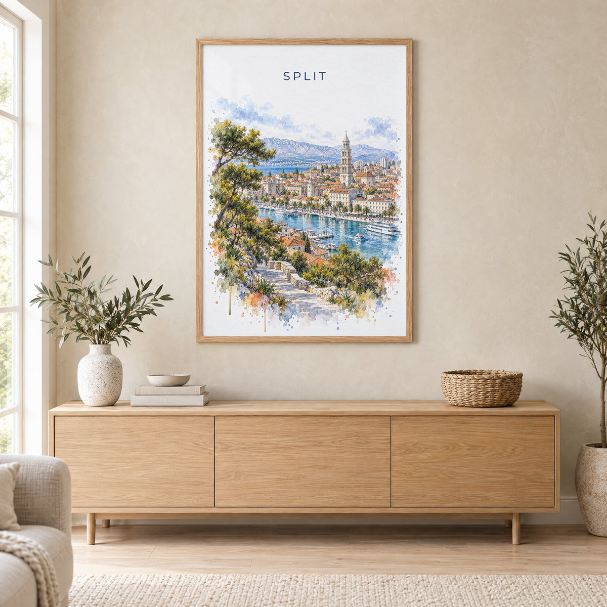 Split, Croatia watercolor print in an oak frame above a light wood sideboard in a Scandinavian living room