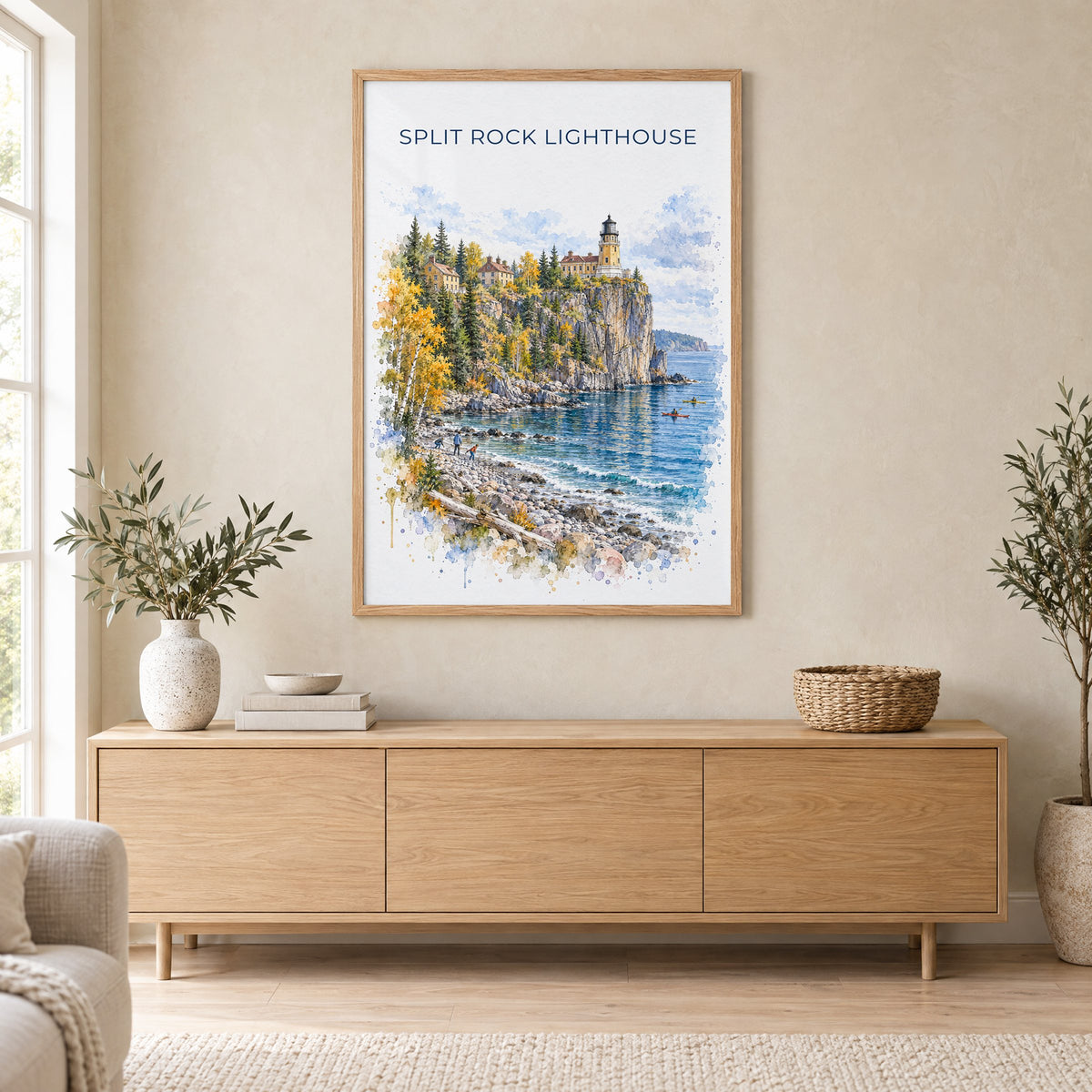 Split Rock Lighthouse watercolor print in an oak frame above a light wood sideboard in a Scandinavian living room